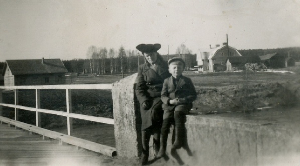 På den här bilden från 1946-47 sitter Beda Westerback tillsammans med systersonen Bo Skogman på broräcket. Till vänster på bilden syns Valters garagebyggnad och till höger Dagsmark Andelsmejeri.