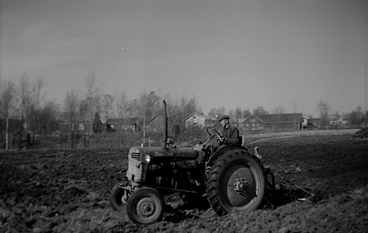 Ragnar med den gamla trotjänaren Zetor 25K. I bakgrunden Westerbacks mäktiga gård på udden. 