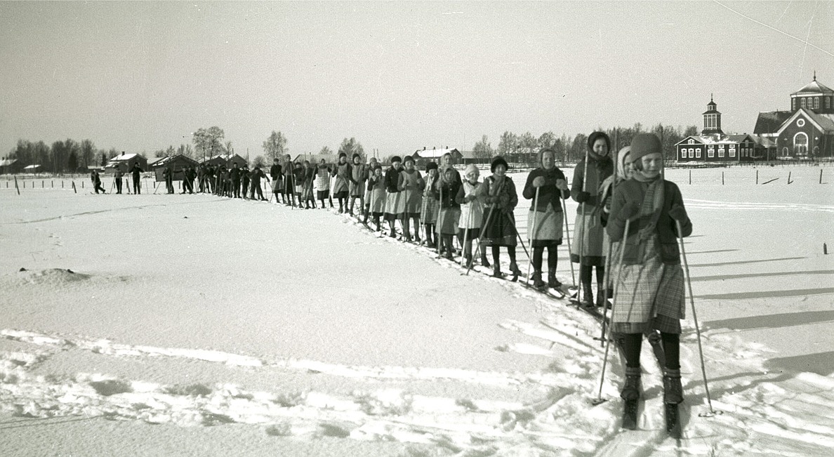 År 1935 användes ingen spårmaskin för att göra skidspår, utan alla banor skidades upp av eleverna. Ett fint foto, som visar dåtidens skiddräktsmode.