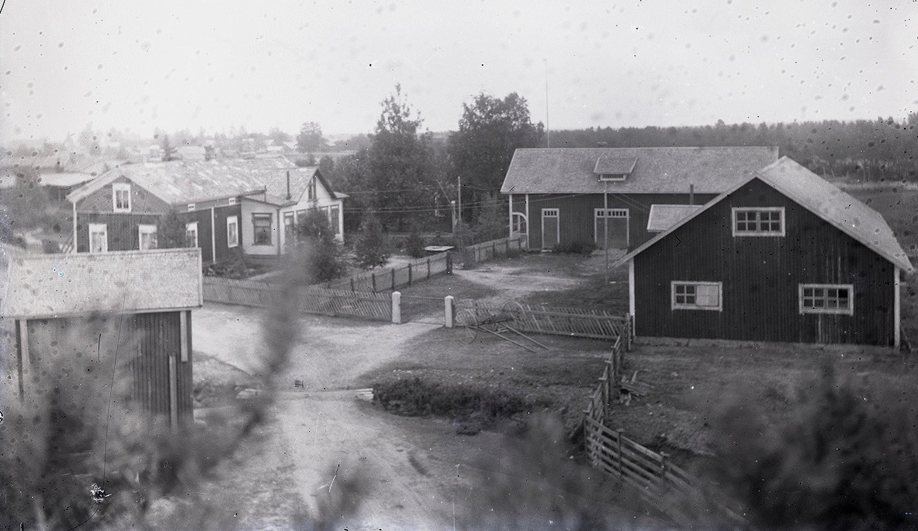 Foto av Nylunds gård taget från den stora tallen nära Sunnantillvägen. Samtliga uthusbyggnader finns kvar ännu men i relativt dåligt skick.