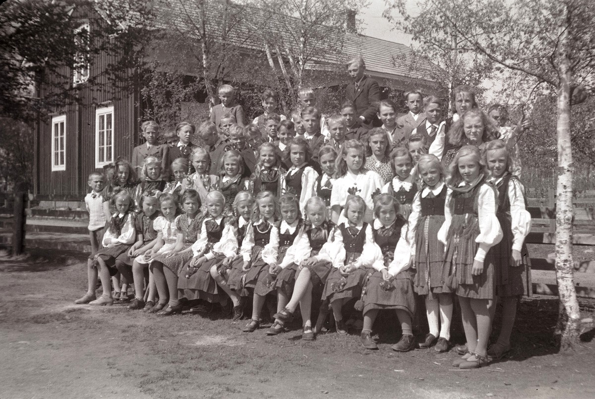 Flera flickor iklädda folkdräkt vid skolavslutningen 1947.