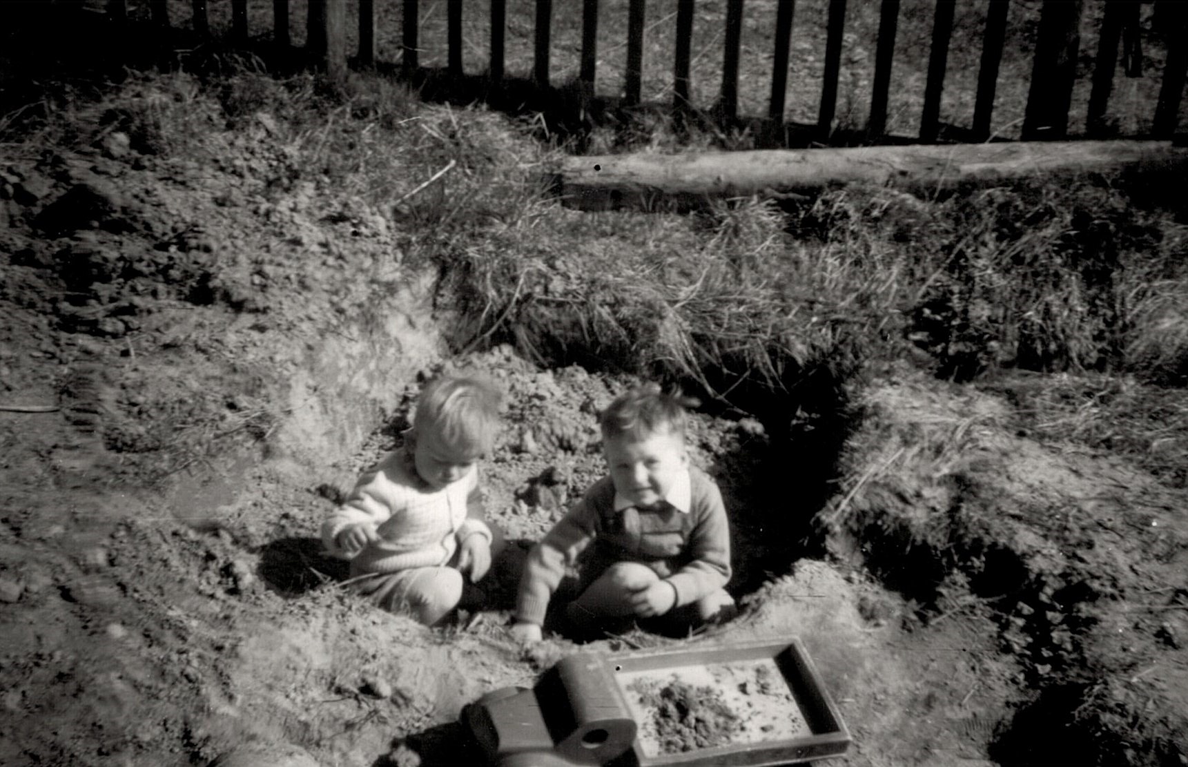 John och Kurt leker ovanpå den nyss uppgrävda "dyngbrånnin" som fanns precis utanför köksfönstret. Fotot från ca 1956.