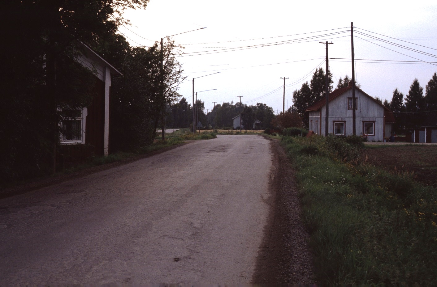 Landsvägen år 1983 med Anderas eller Grans Lennart till vänster , mitt i bild Kangas Velis hus och längst till höger Artur Lövholms gård.